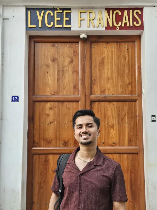 Kousik standing outside the Lycée Français