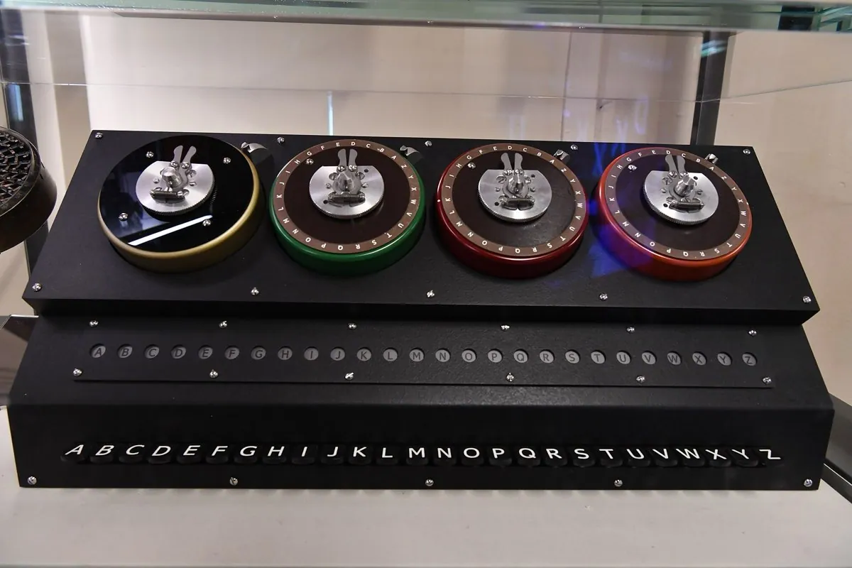 A rebuilt wartime electromechanical machine with a large rotating drum of wired contacts, standing in a hut at Bletchley Park.