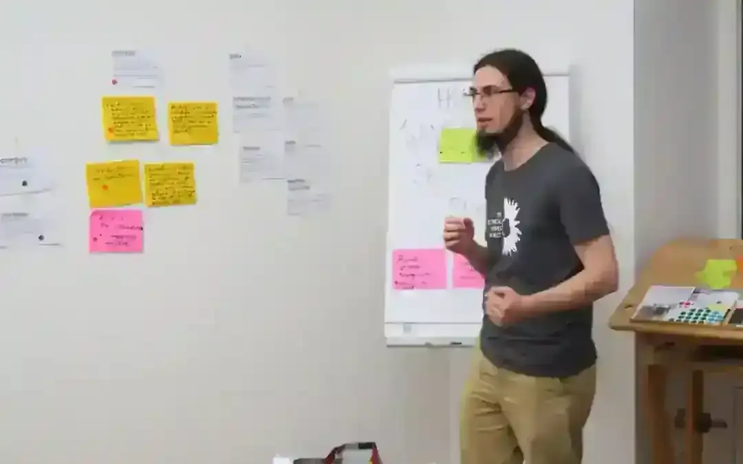 Two people talk closely together during a hands-on visioning exercise at a design workshop.